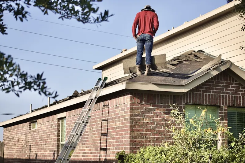 Professional roofer working on a residential roof in Redland Woods